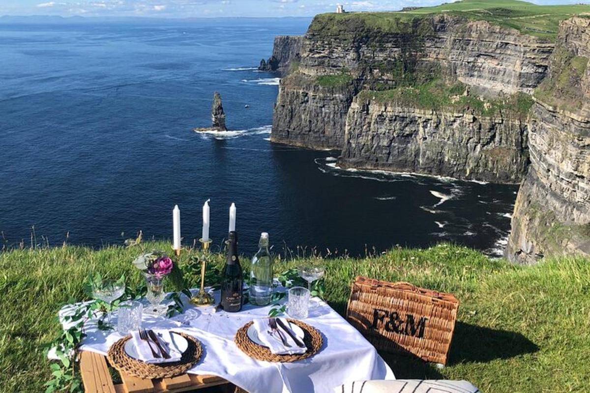 a table with a view of the ocean and cliffs