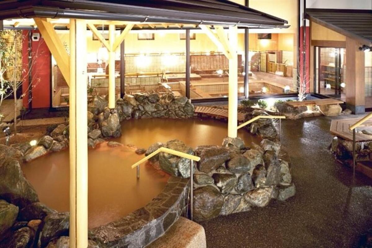 a pool of water in a room with rocks