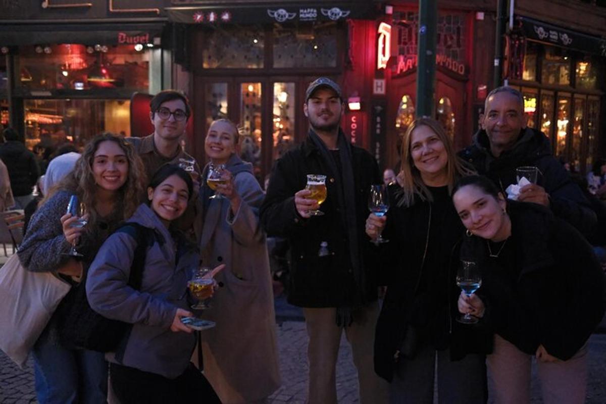 a group of people posing for a picture with wine glasses