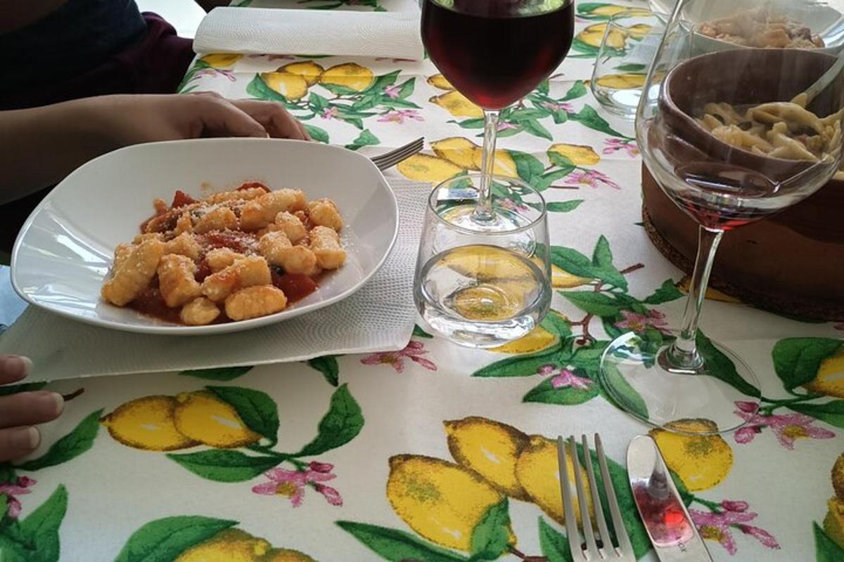 a table with a plate of food and a glass of wine