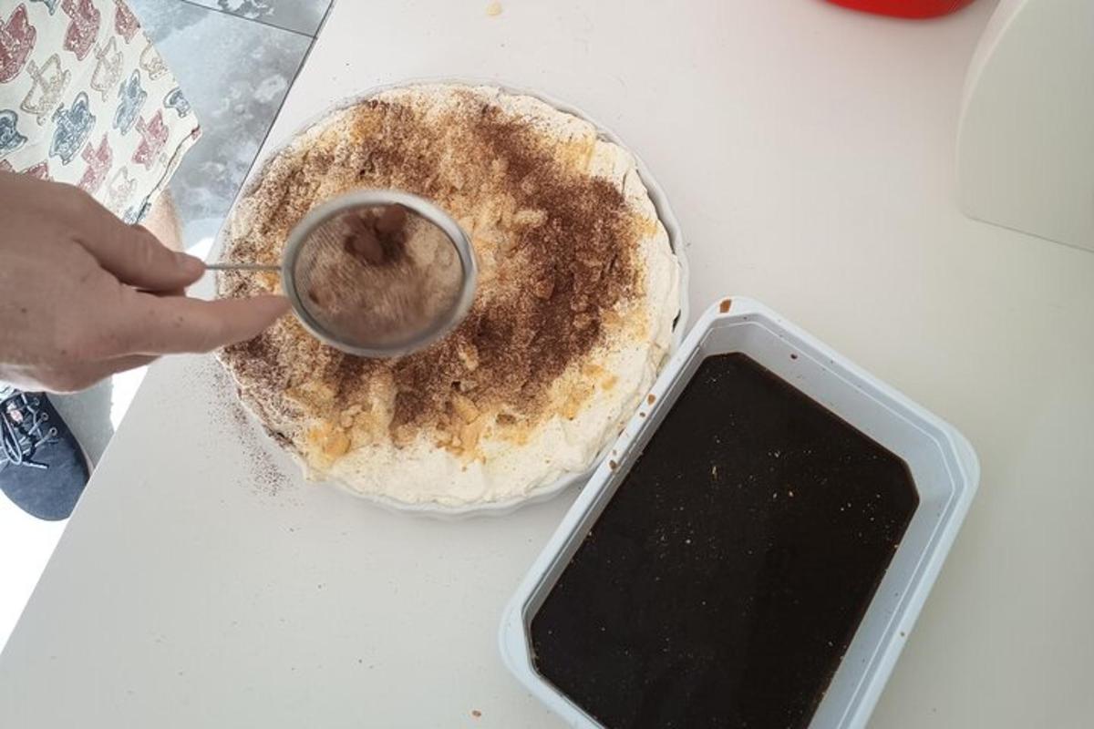 a person dipping a doughnut in a cup of chocolate