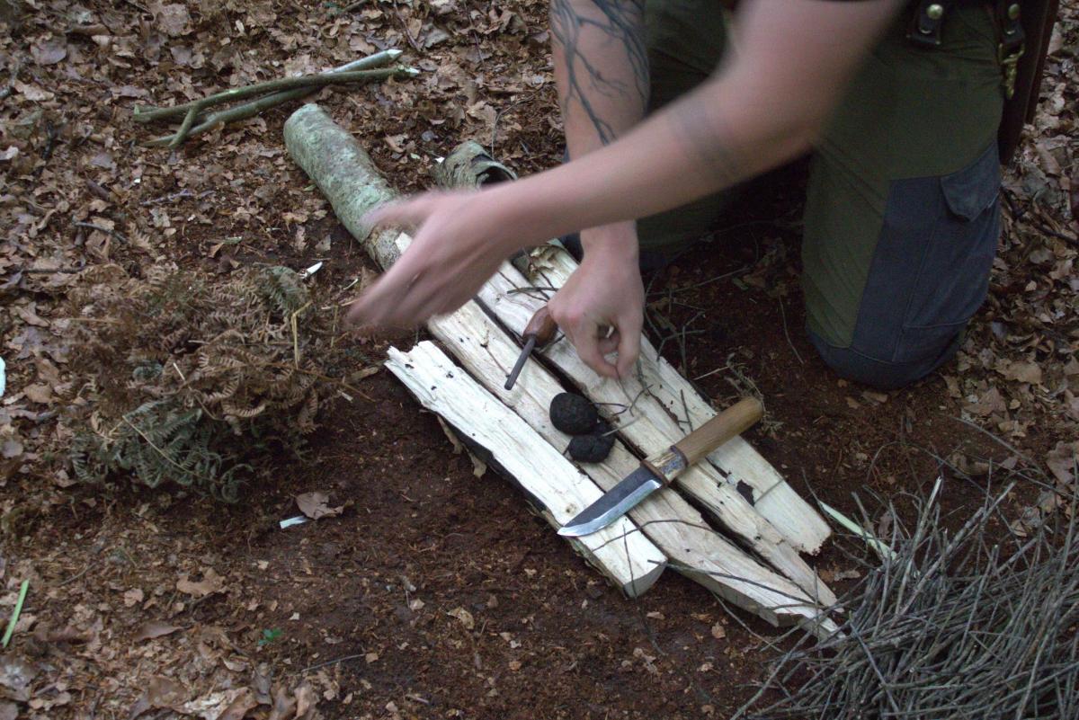 a person is making a pile of wooden sticks