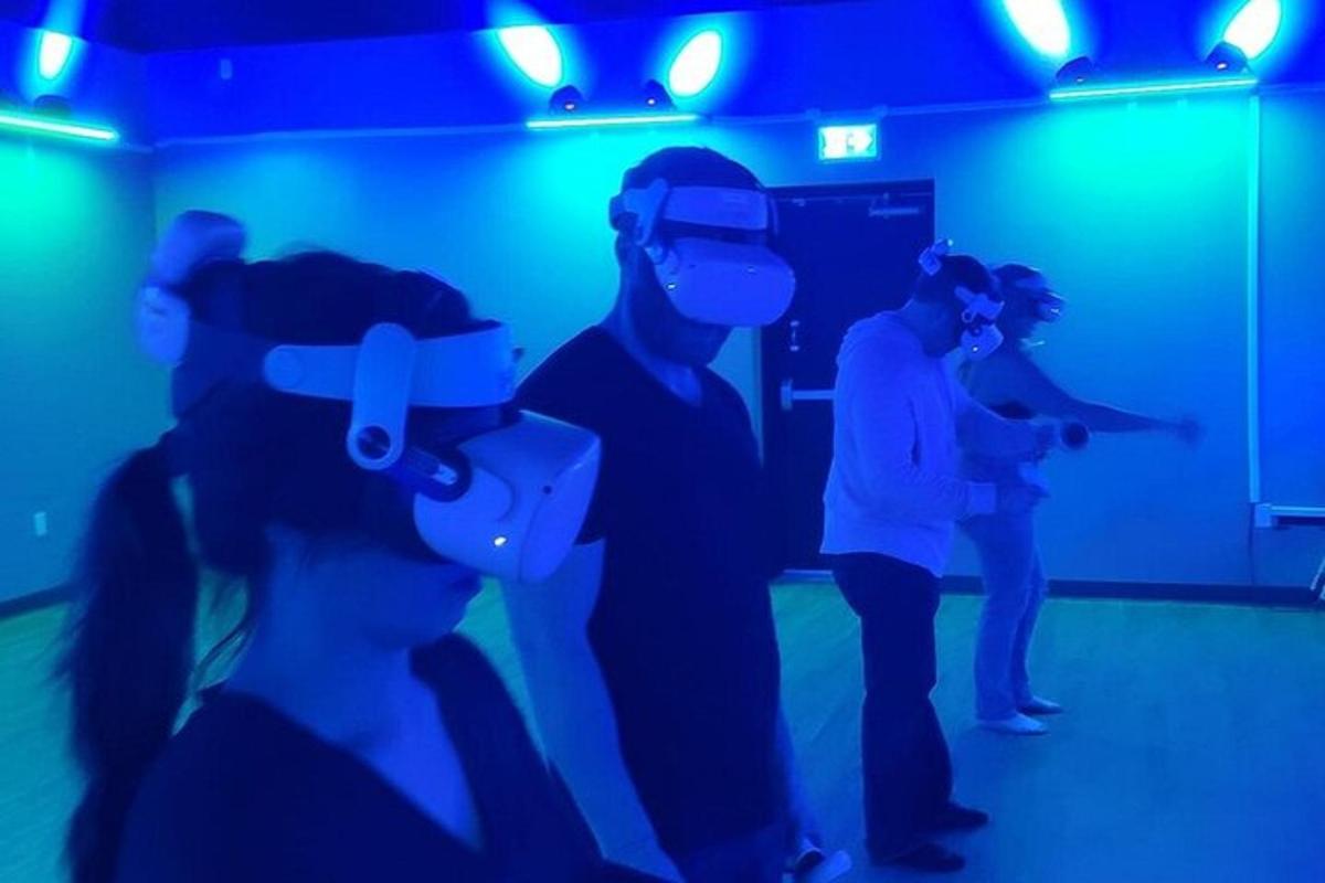 a group of people in a room wearing virtual reality headsets