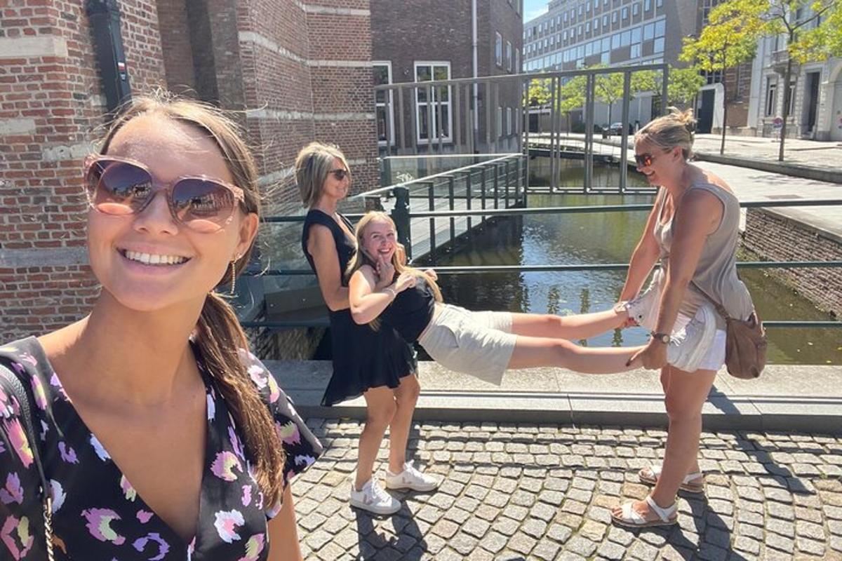 a group of young women standing next to a pond