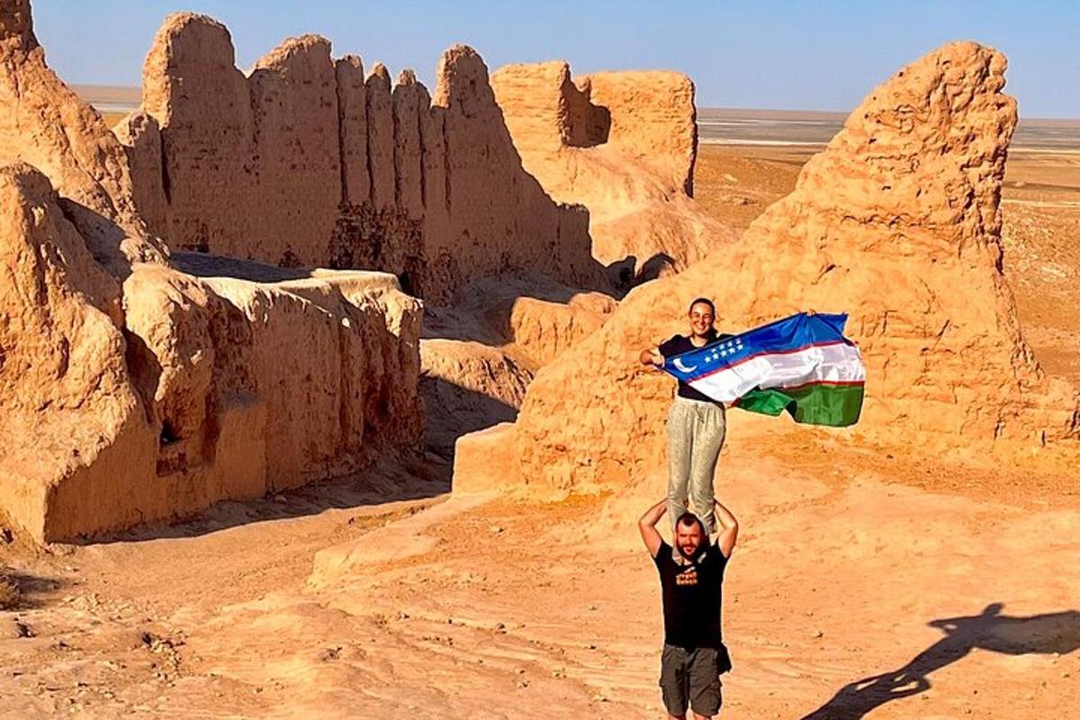 two men are standing on the desert with a flag