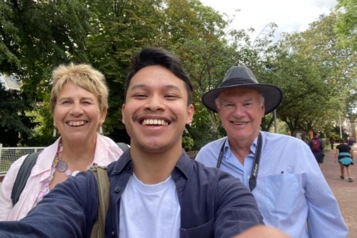 a group of three people posing for a picture