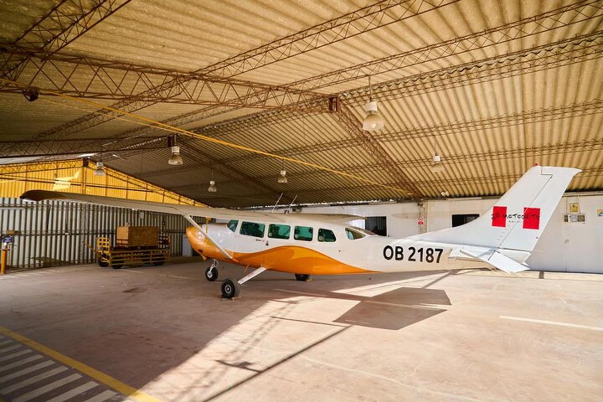 a small plane is parked in a hangar