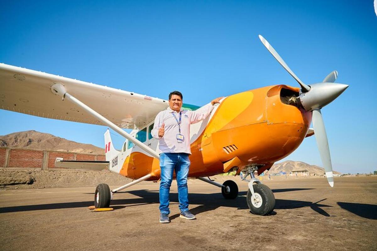 a man standing in front of a small plane