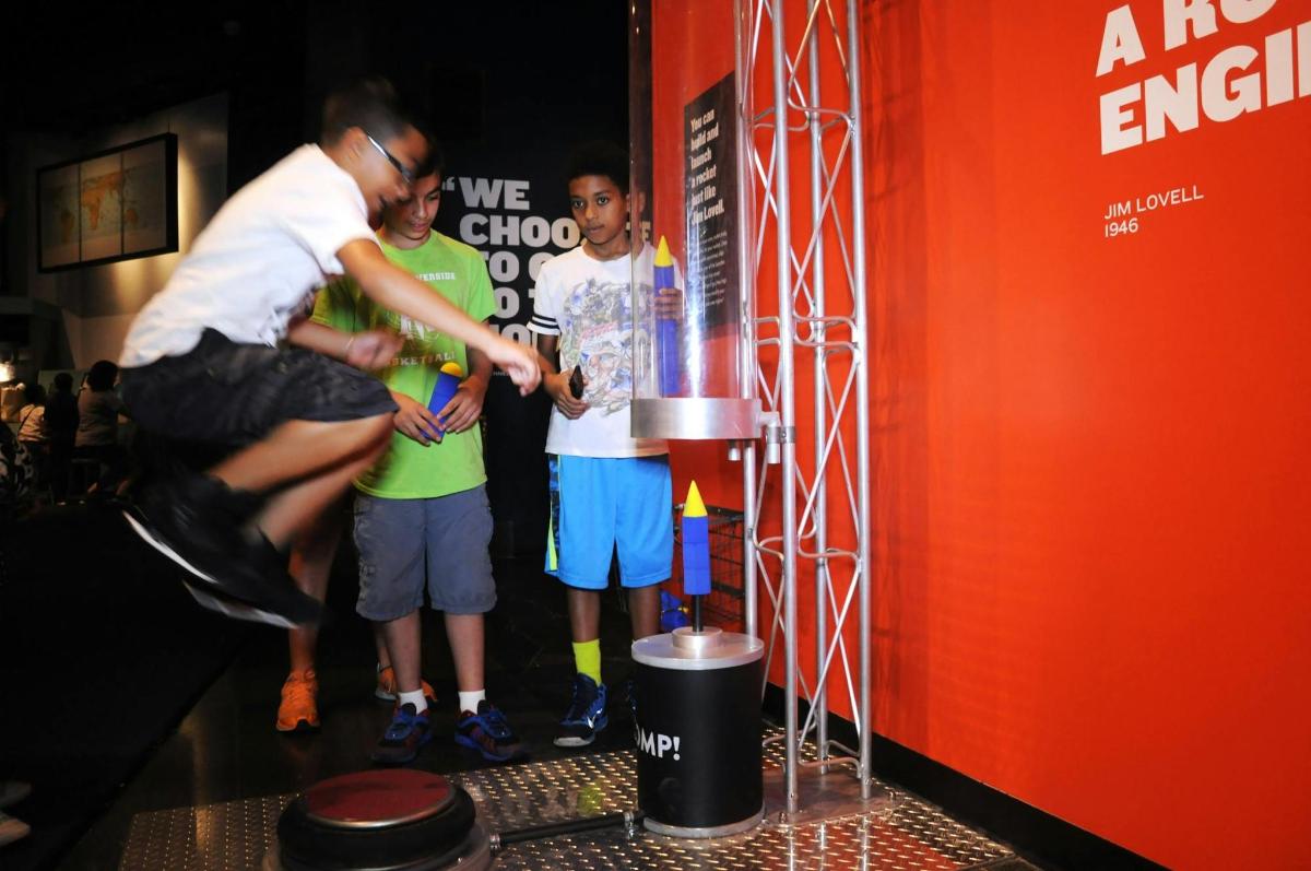 a group of people standing in front of a trophy