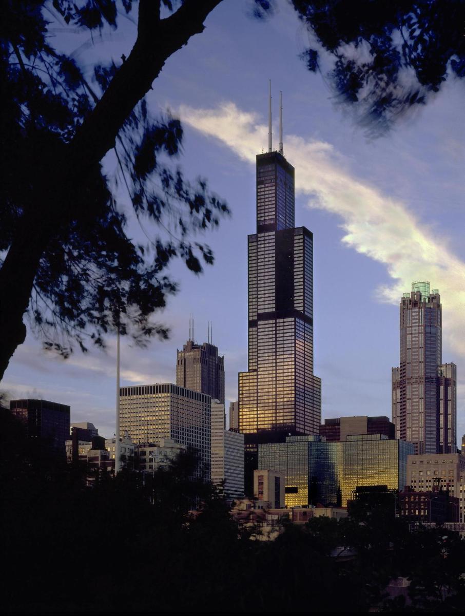 a view of a city skyline with a tall skyscraper