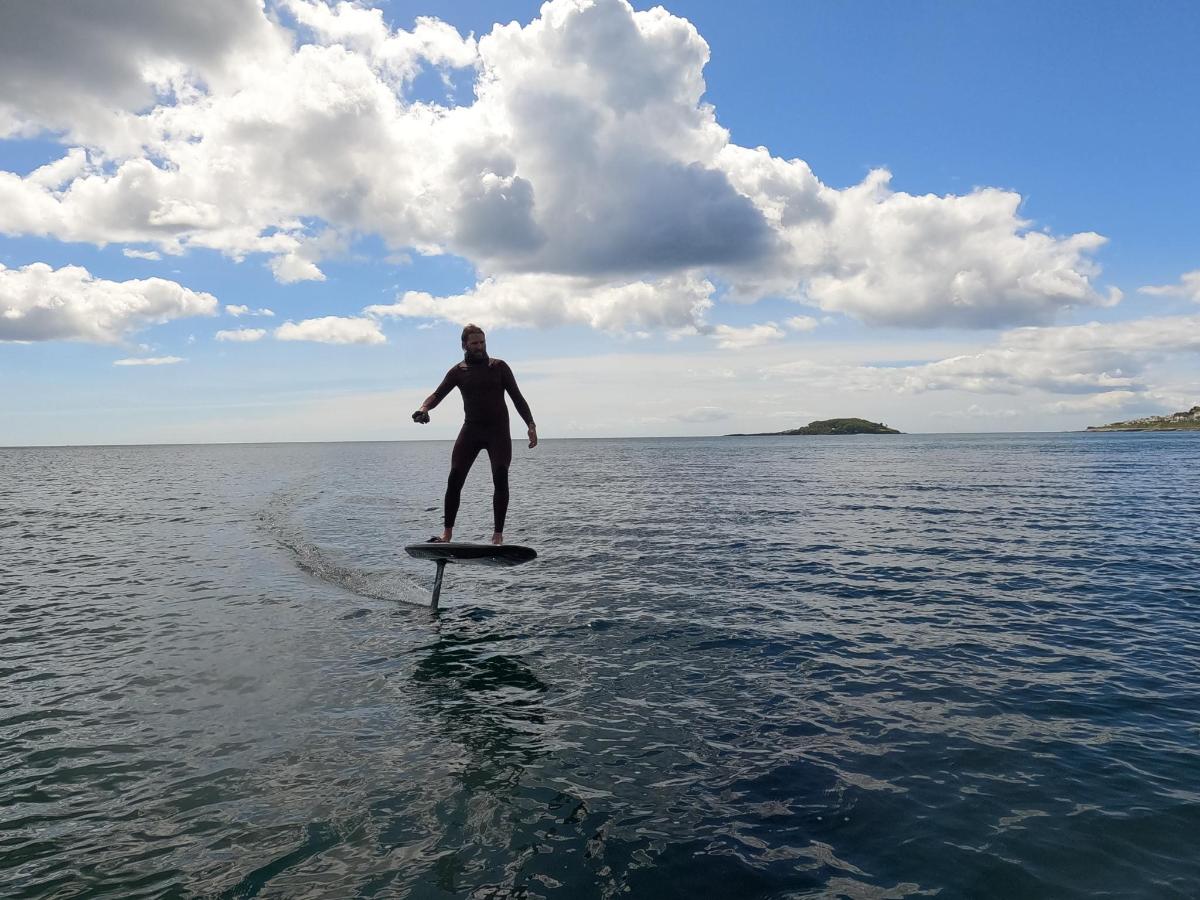 a man standing on a surfboard in the water