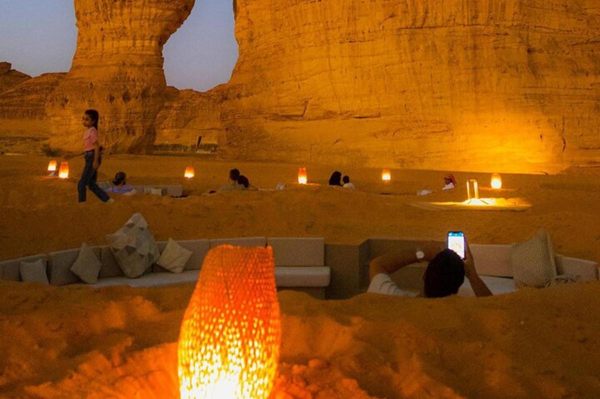 a person taking a picture of a desert at night