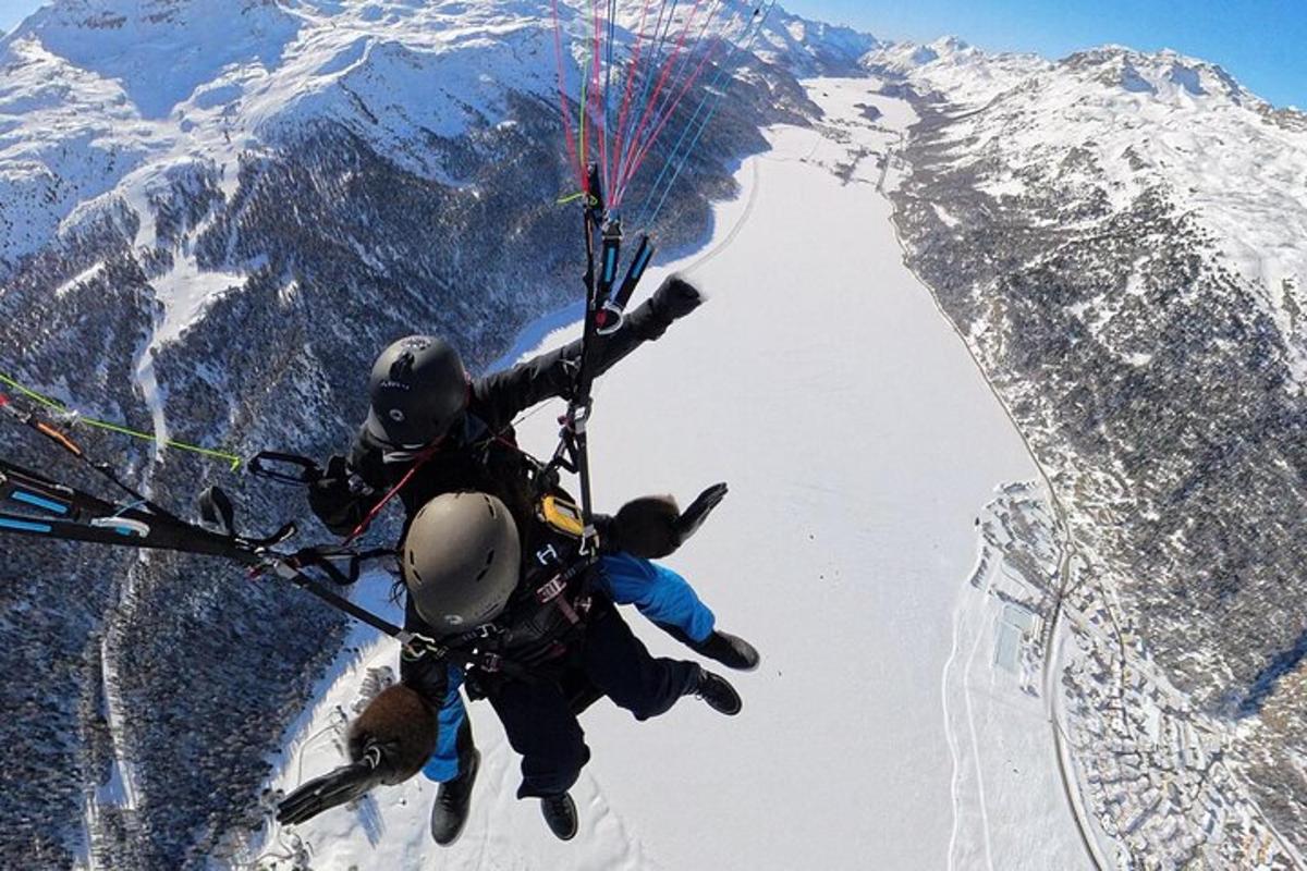 a group of people falling off of a mountain with a parachute