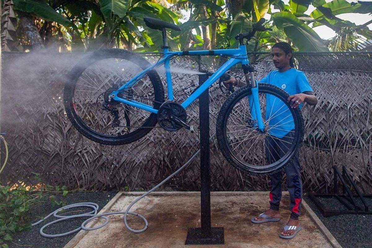 a man is washing a bike on a pole