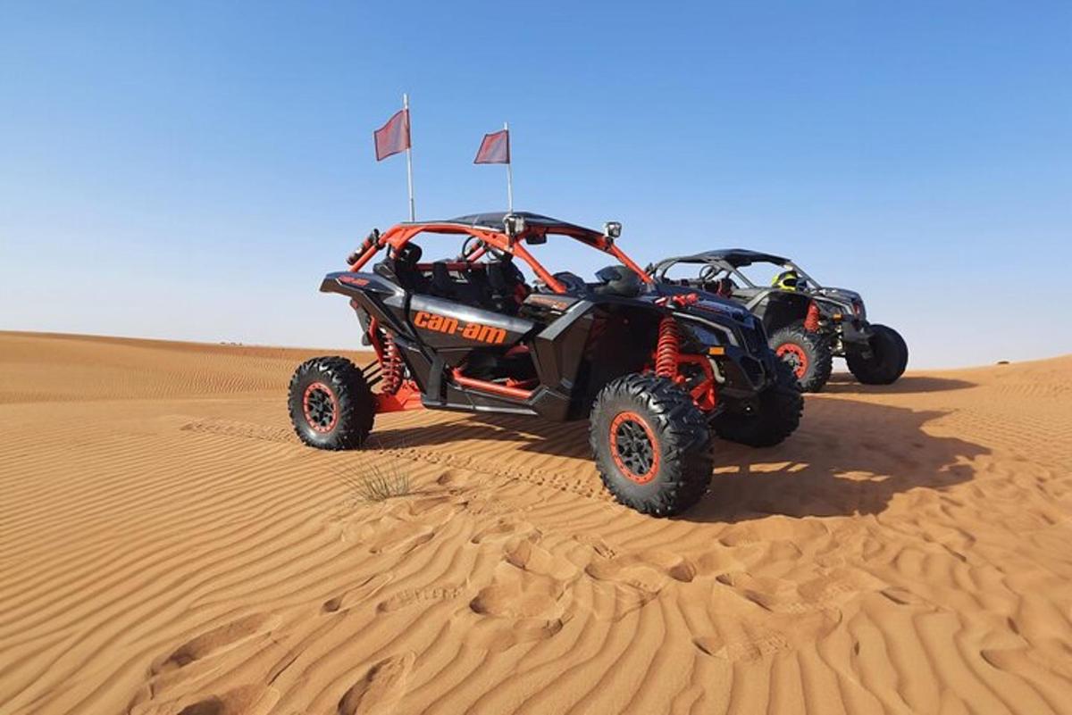 two atvs parked in the sand in the desert