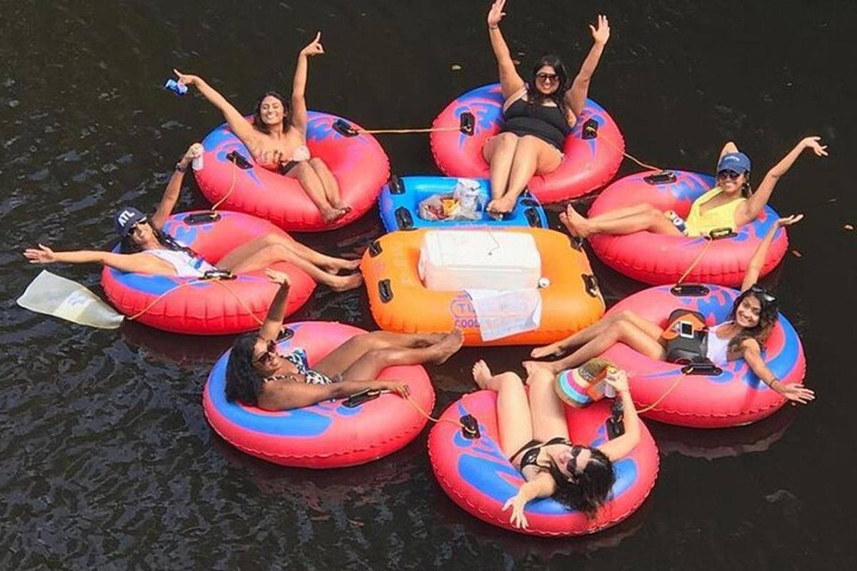 a group of people riding onlatable tubes in the water