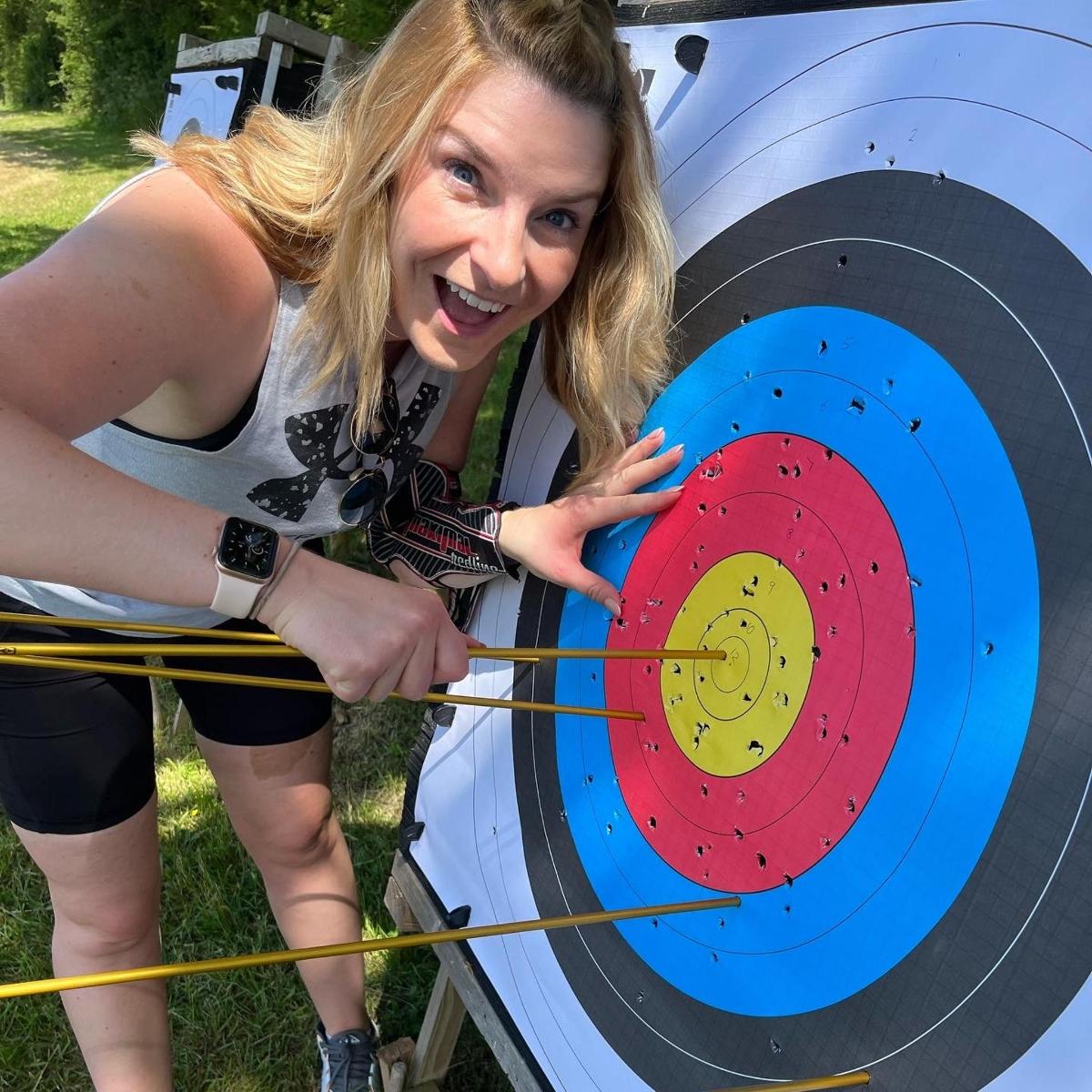 a woman standing next to a target