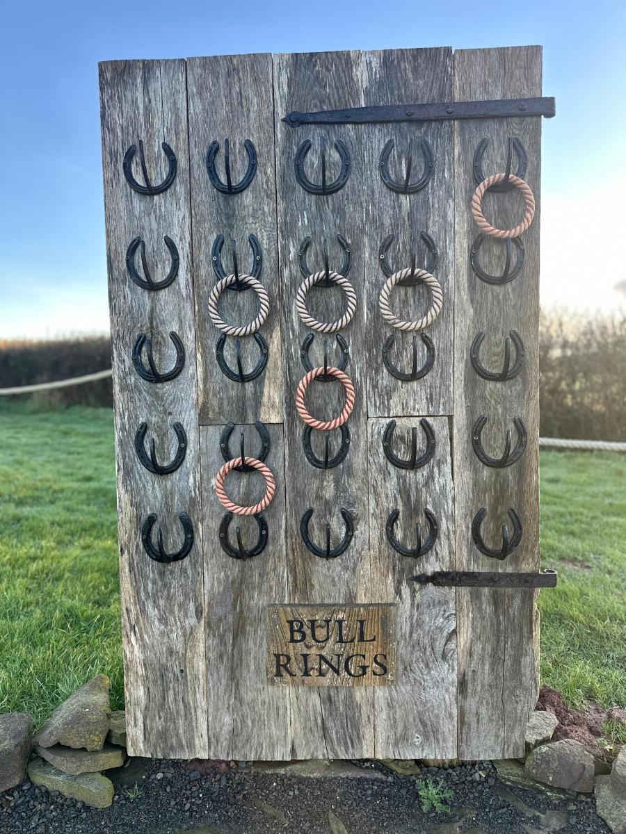a sign with horseshoes on a wooden wall