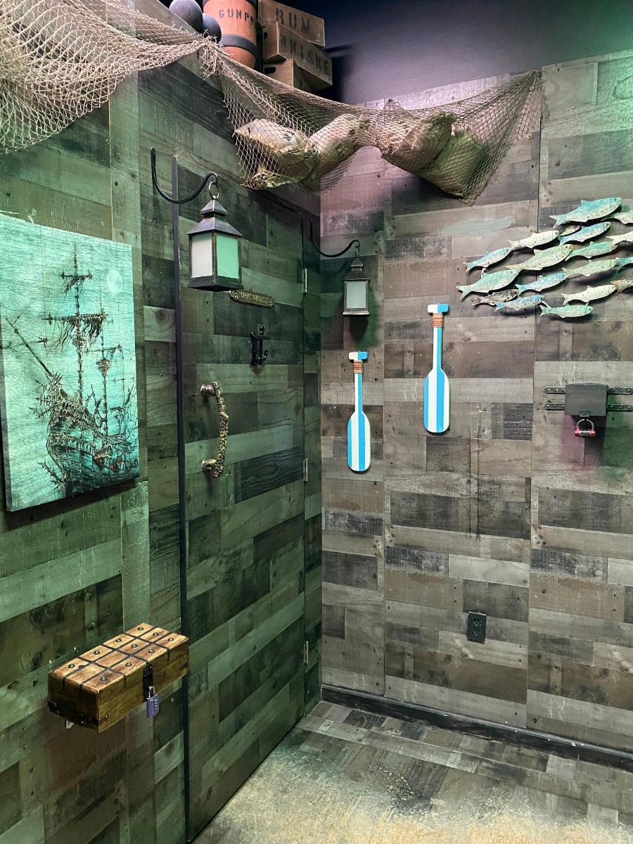 a bathroom with a wooden wall with vases on it