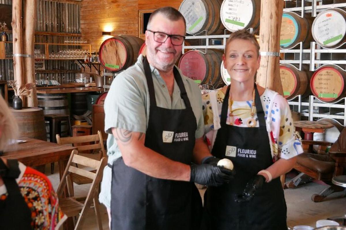 a man and a woman standing in a wine shop