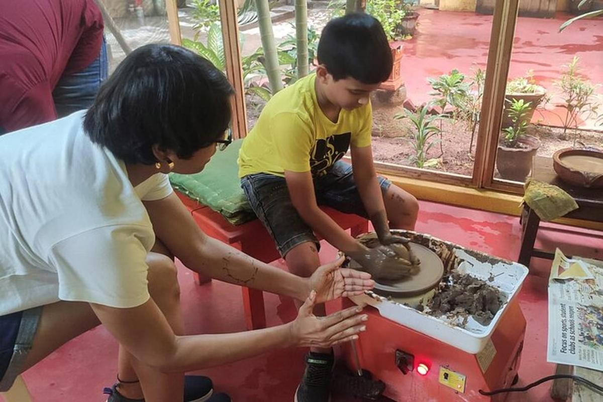 a woman and a young boy playing with a machine