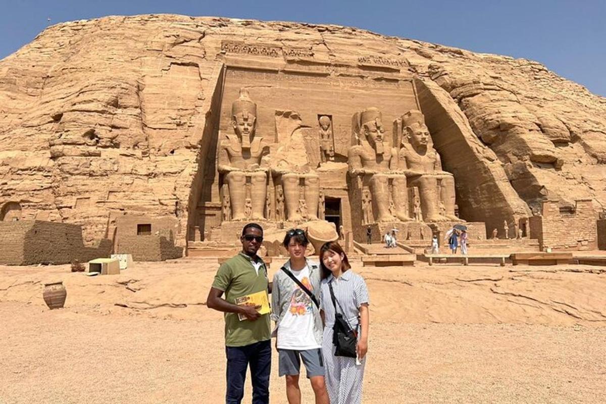 a group of people standing in front of a statue