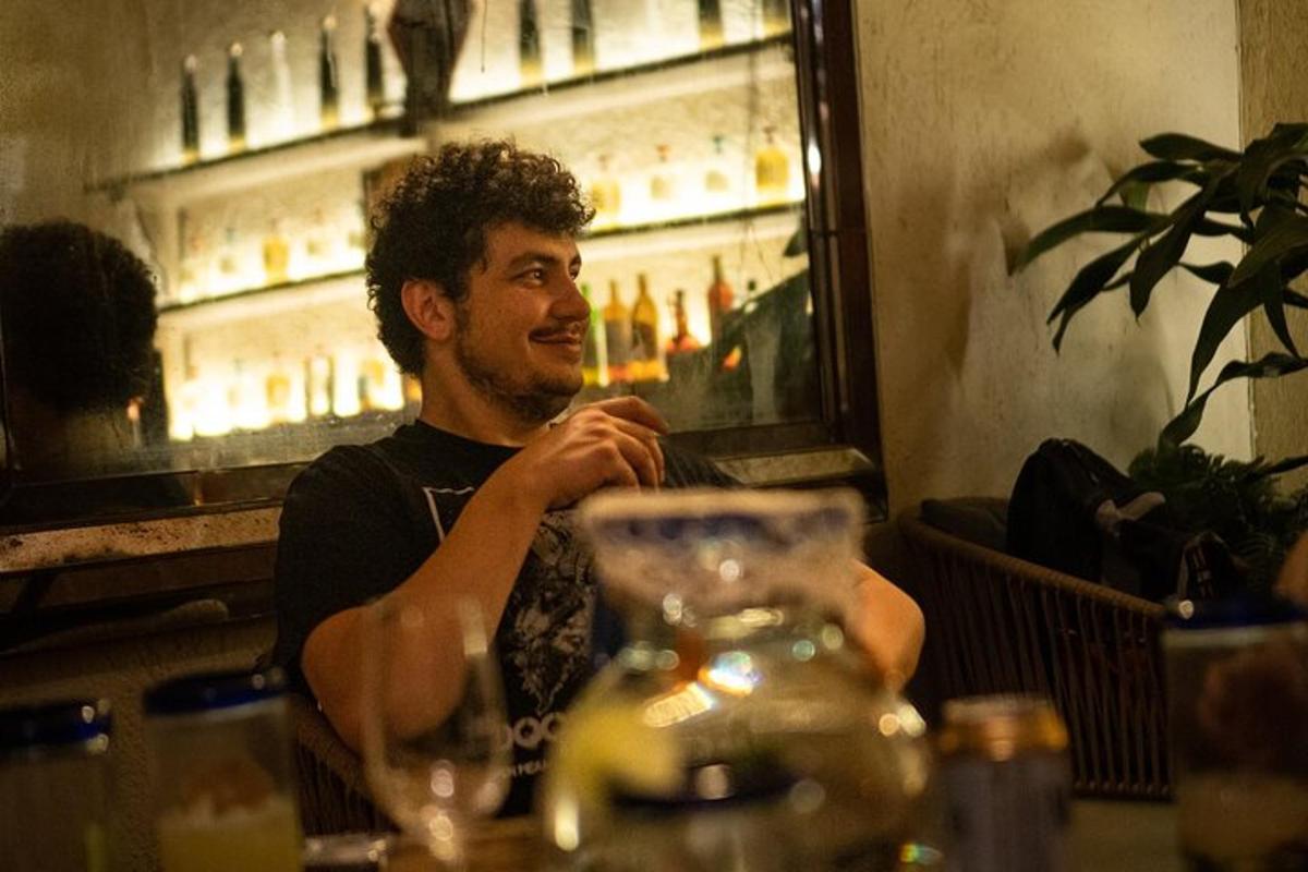 a man sitting at a table in a bar