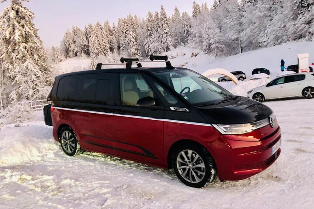 a small red car parked in the snow