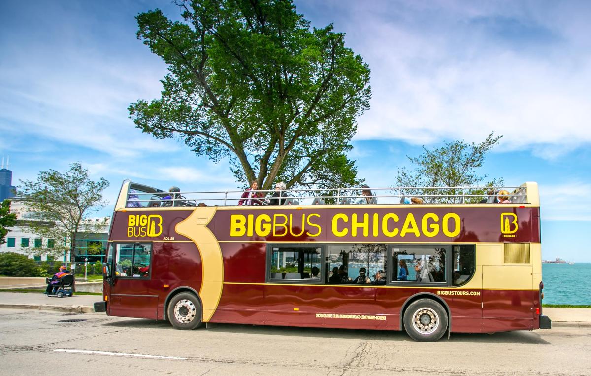 a red double decker bus driving down a street
