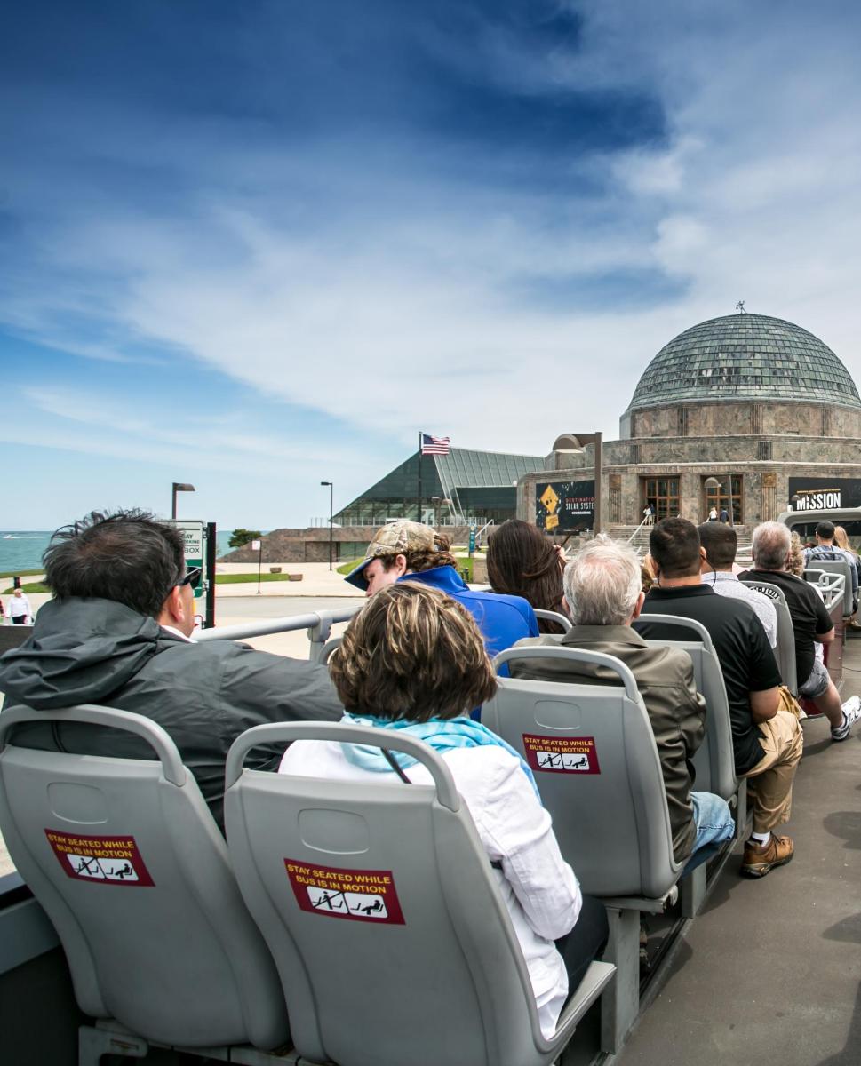 a group of people sitting in seats on a bus