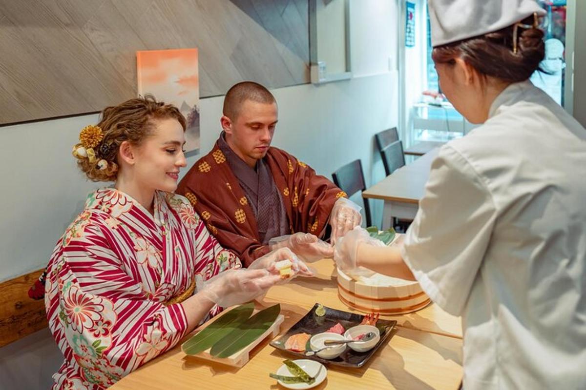 a woman sitting at a table talking to a chef