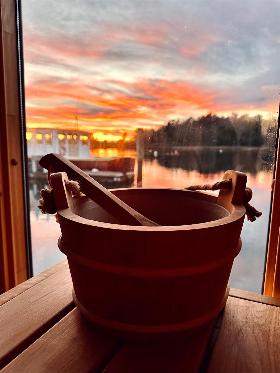 a wooden bucket sitting on a window sill with a view