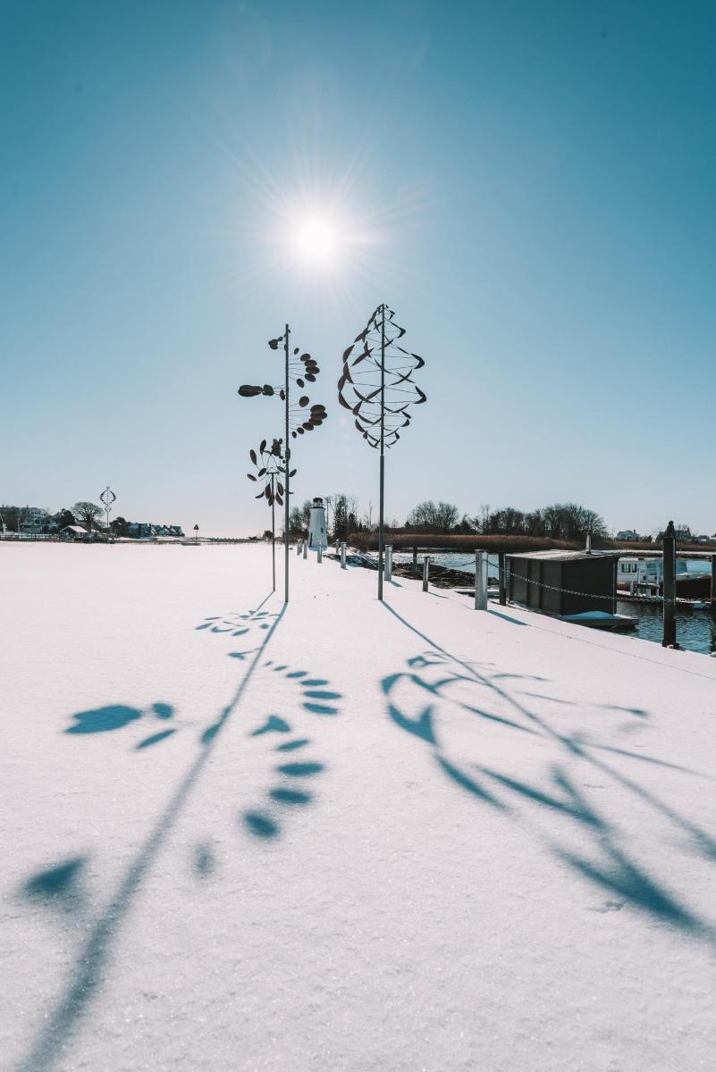 a group of footprints in the snow next to street lights