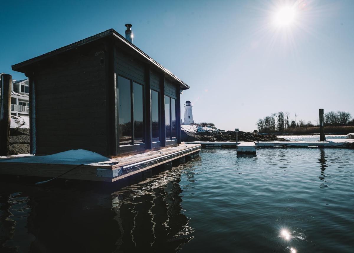 a small building on a dock in the water
