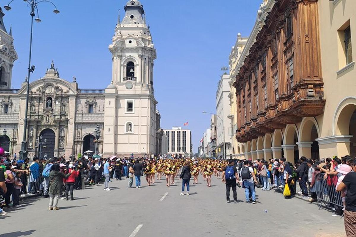 a crowd of people walking down a street in front of a building