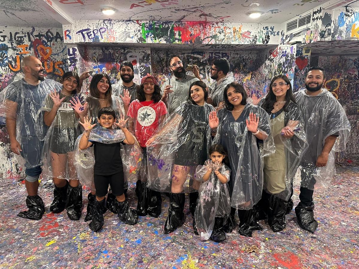 a group of people standing in a room covered in paint