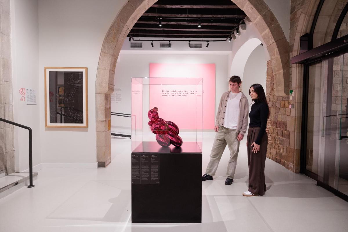 a man and a woman standing in an art exhibit