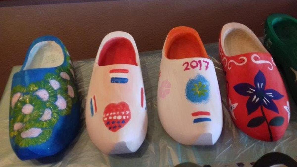 a group of four painted shoes sitting on a table