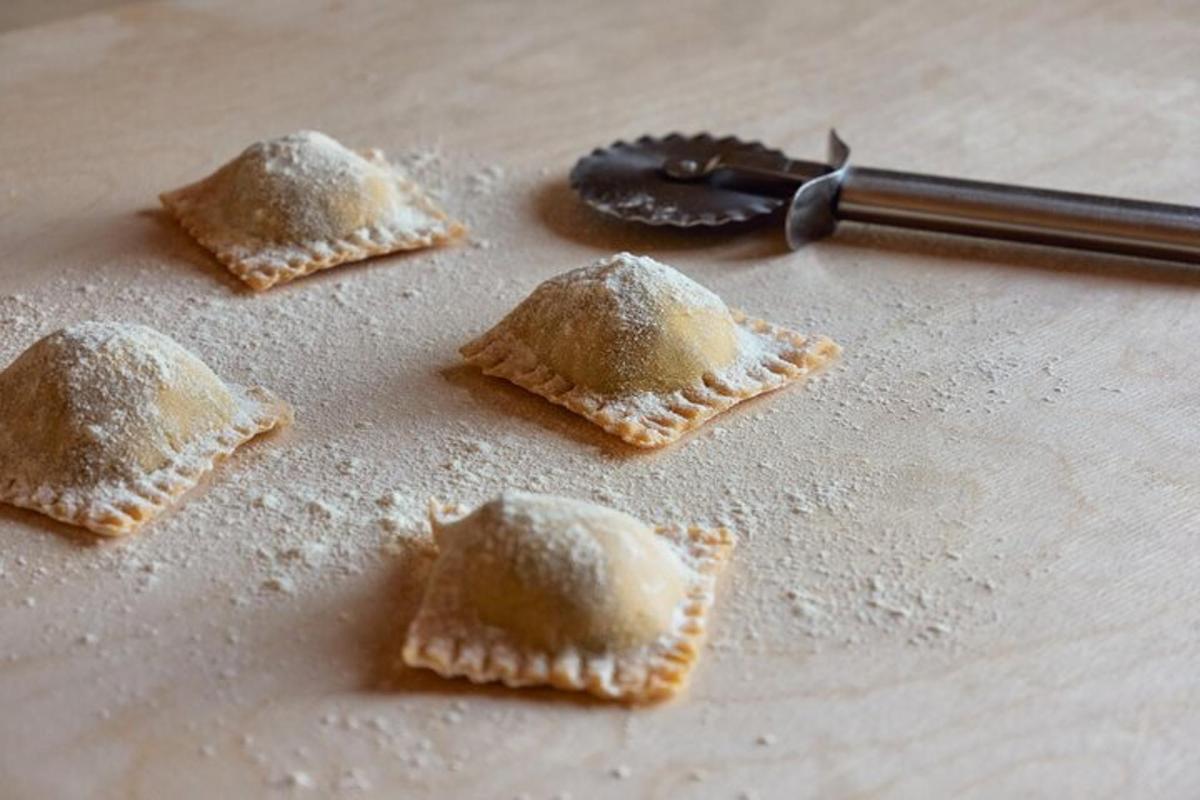 a cookie sheet with a pie crust being cut up