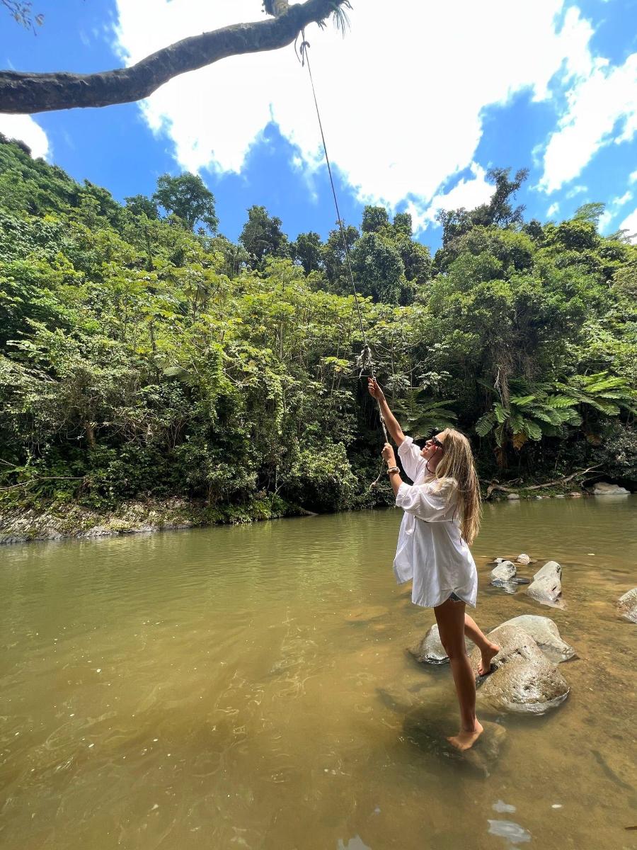 a woman in the water reaching up into the air