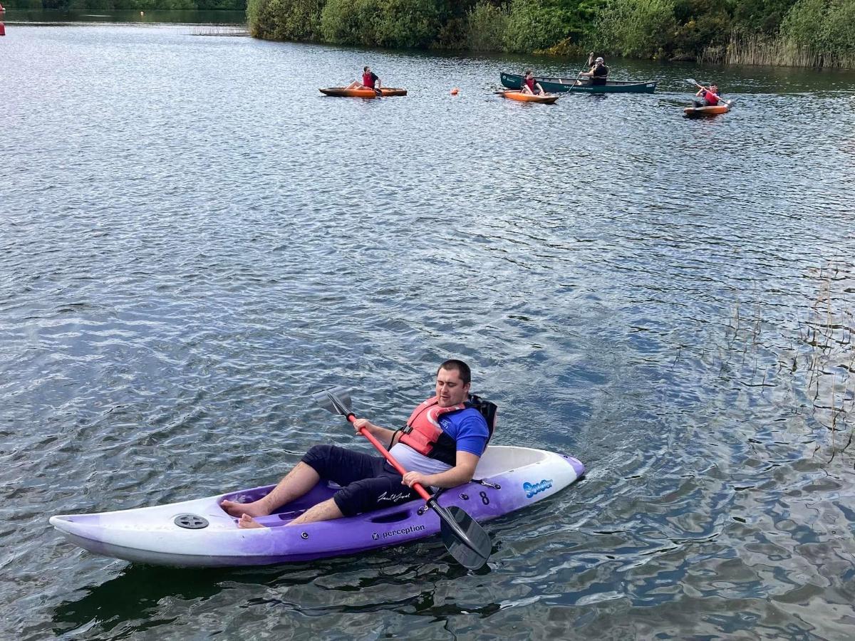 a man is sitting on a kayak in the water