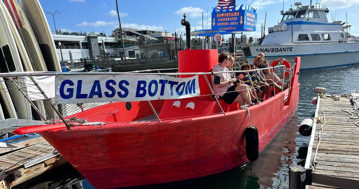 a group of people on a red boat at a dock