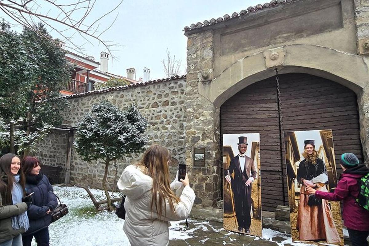 a woman taking a picture of a man in a painting