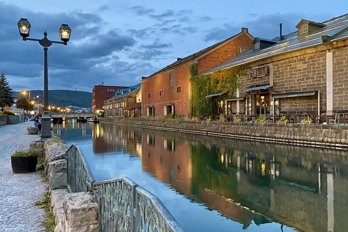 a street light next to a river with buildings