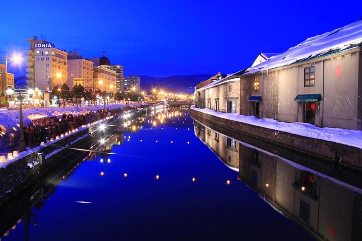 a river in a city at night with buildings