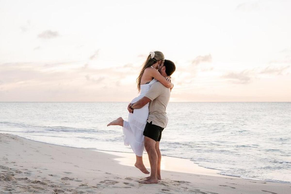 a man carrying a woman on the beach