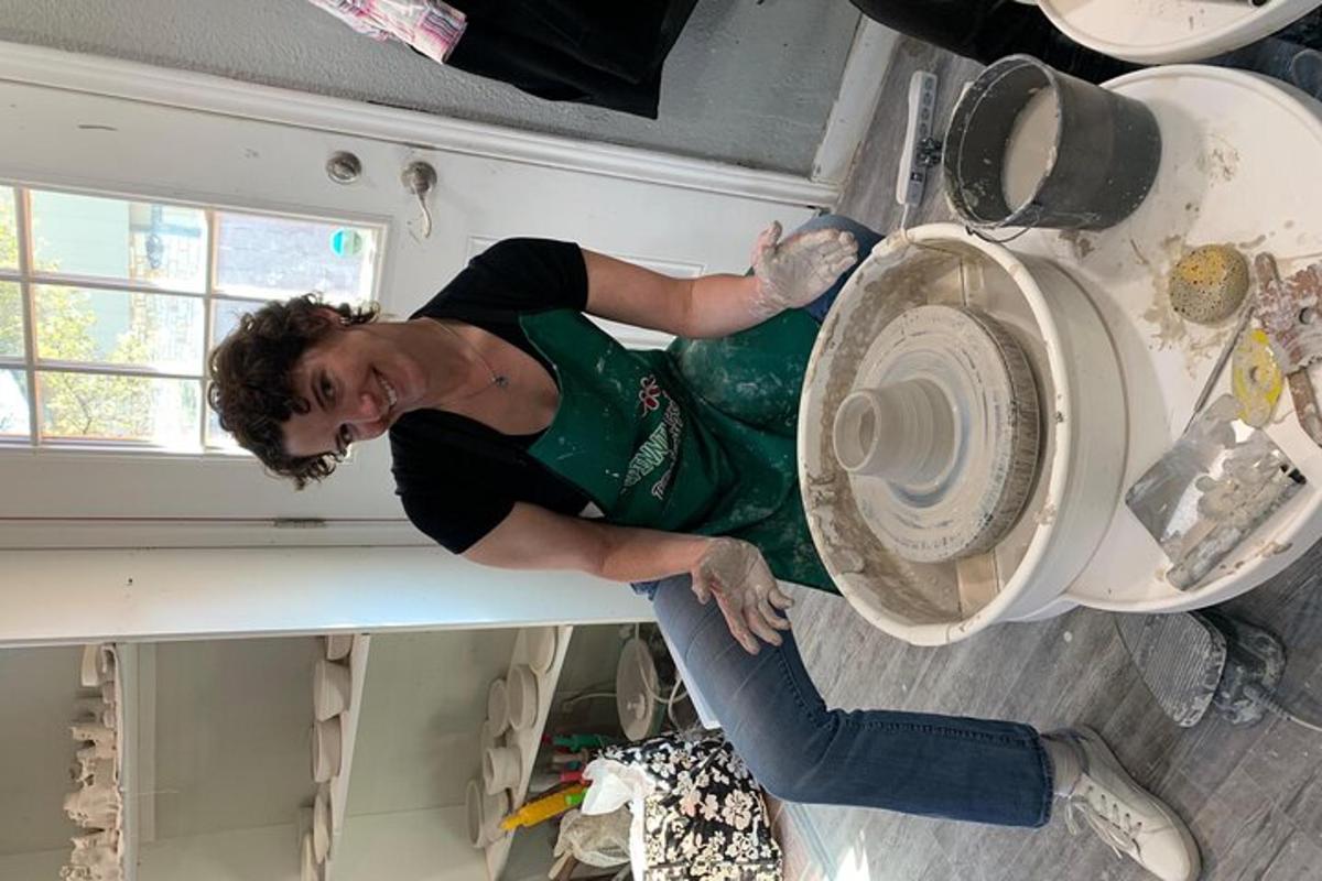 a woman sitting on a counter next to a washing machine
