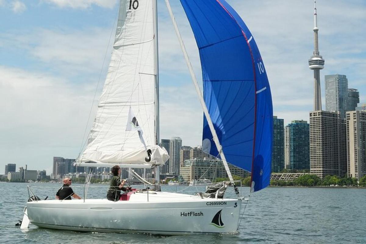 a couple of people on a sail boat in the water