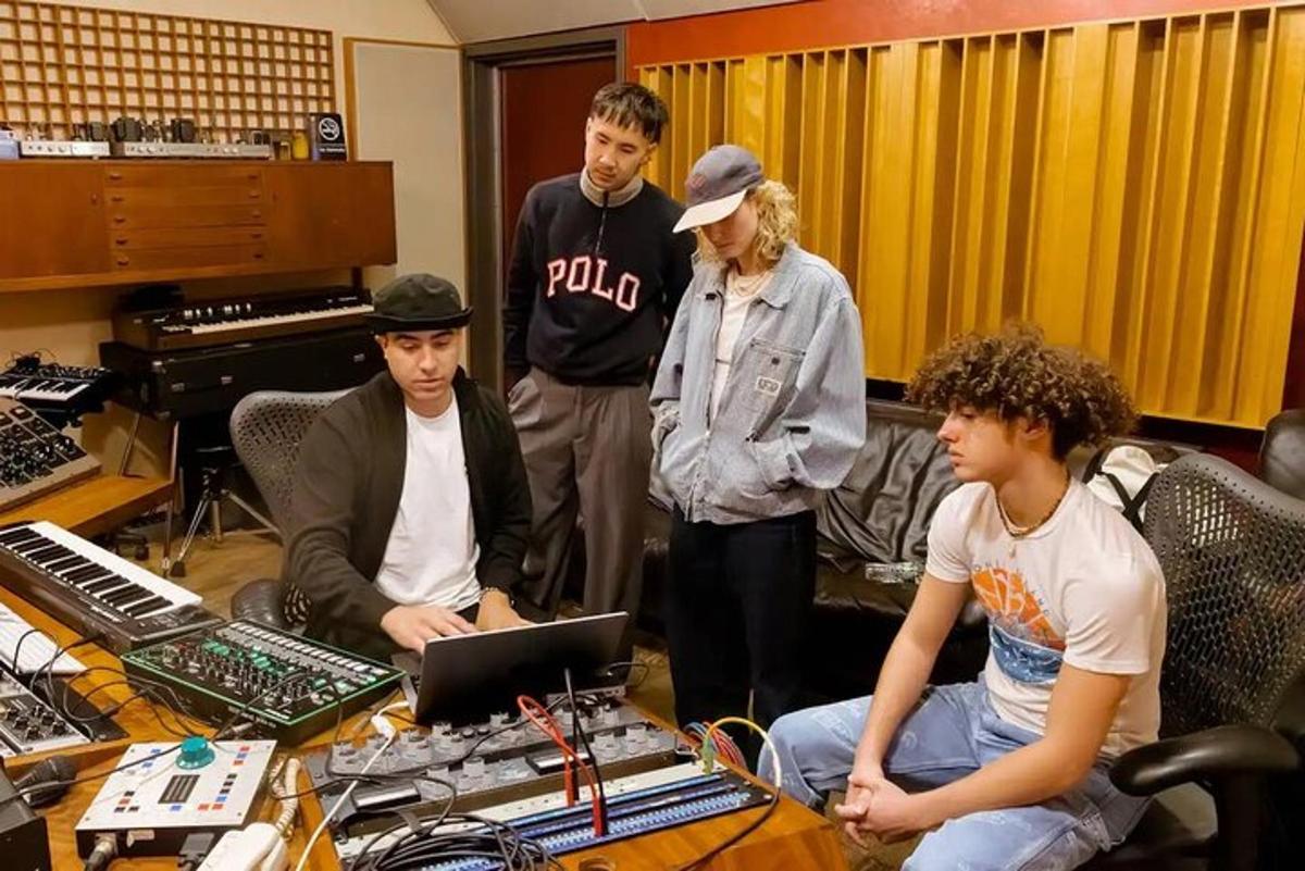 a group of people standing in a recording room