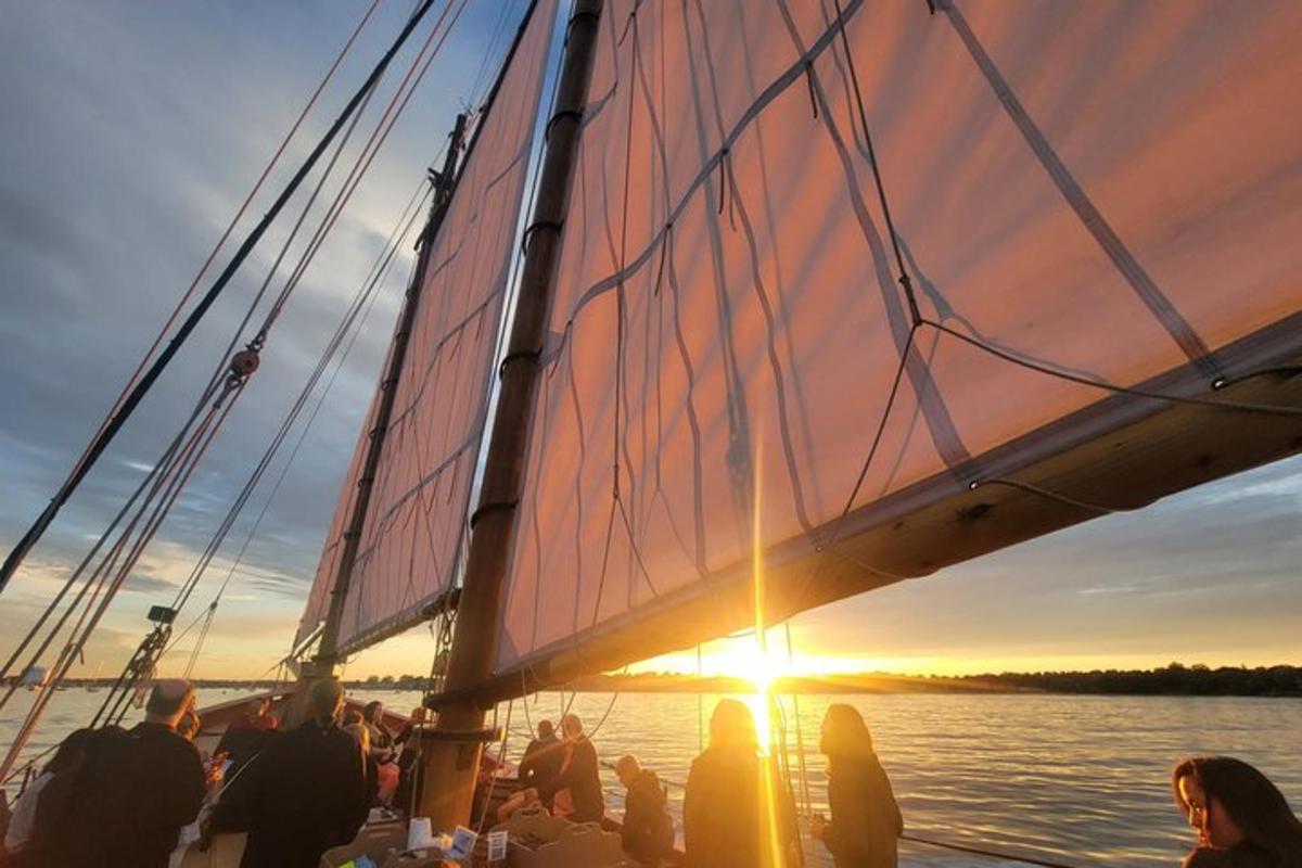 a group of people on a boat at sunset